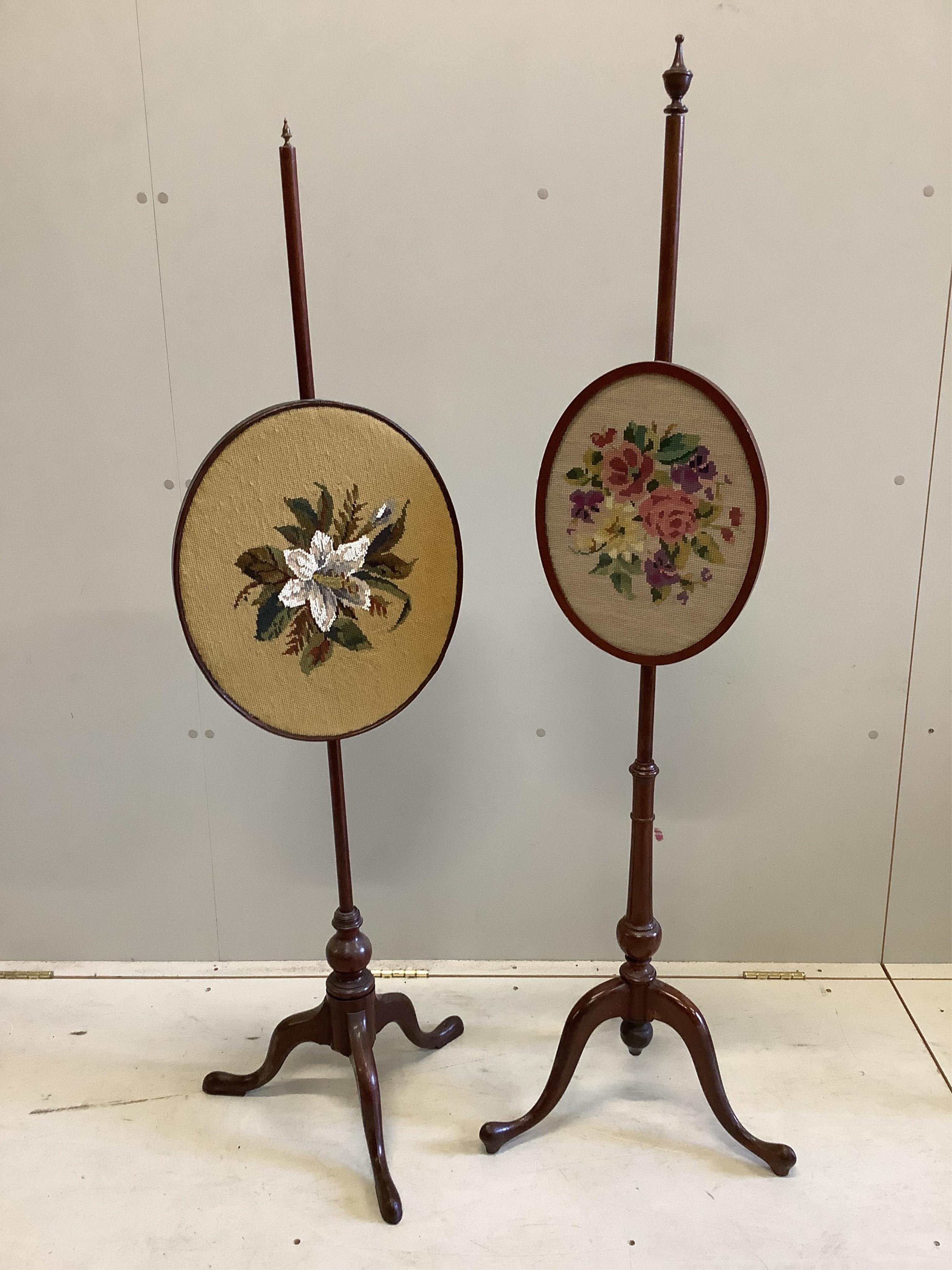 Two Edwardian mahogany pole screens with oval tapestry banners, larger height 148cm. Condition - fair-good